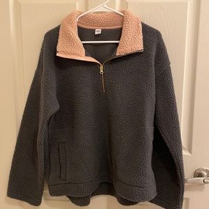Gray pullover with light pink collar. Pockets on the front and gold quarter zip